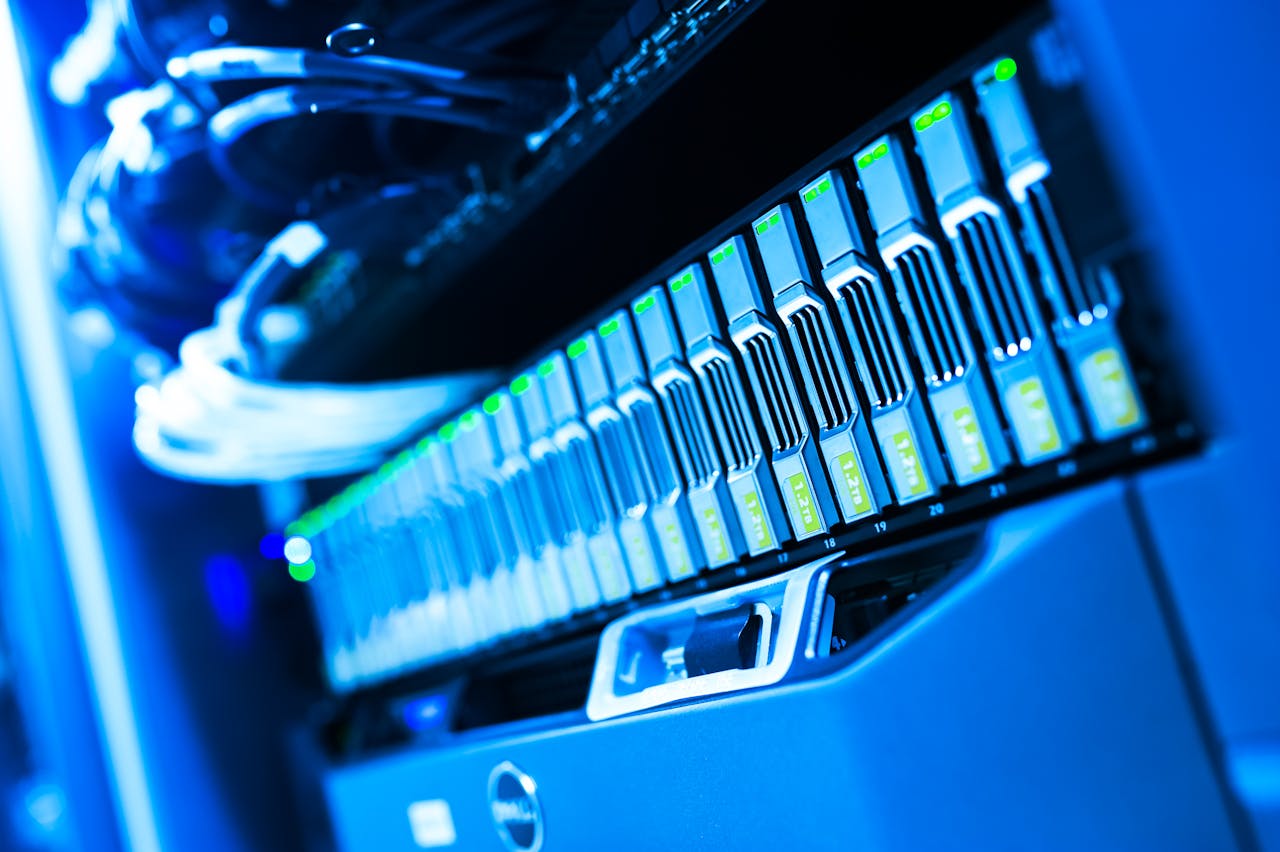 about-01 A detailed view of a blue lit computer server rack in a data center showcasing technology and hardware.