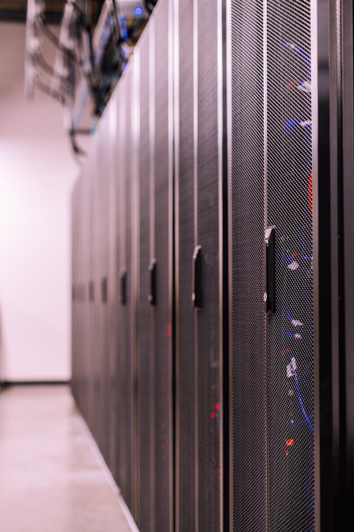 services-02 Row of similar lockers with various optic fiber cables in modern data server room